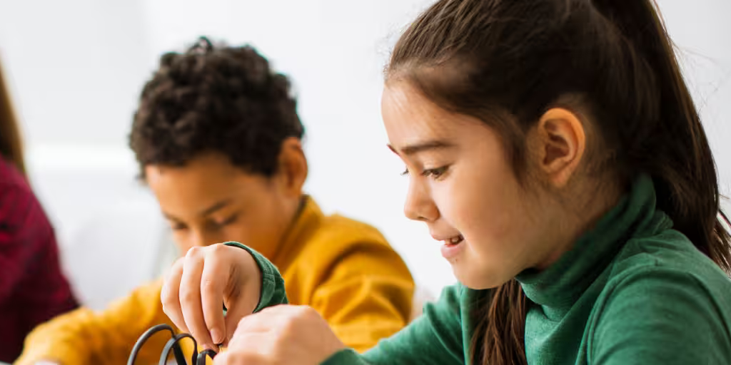 Teacher helping students with a lesson at Learning Beam Academy